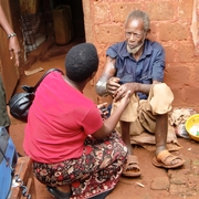Rose talks with a patient in a remote village.